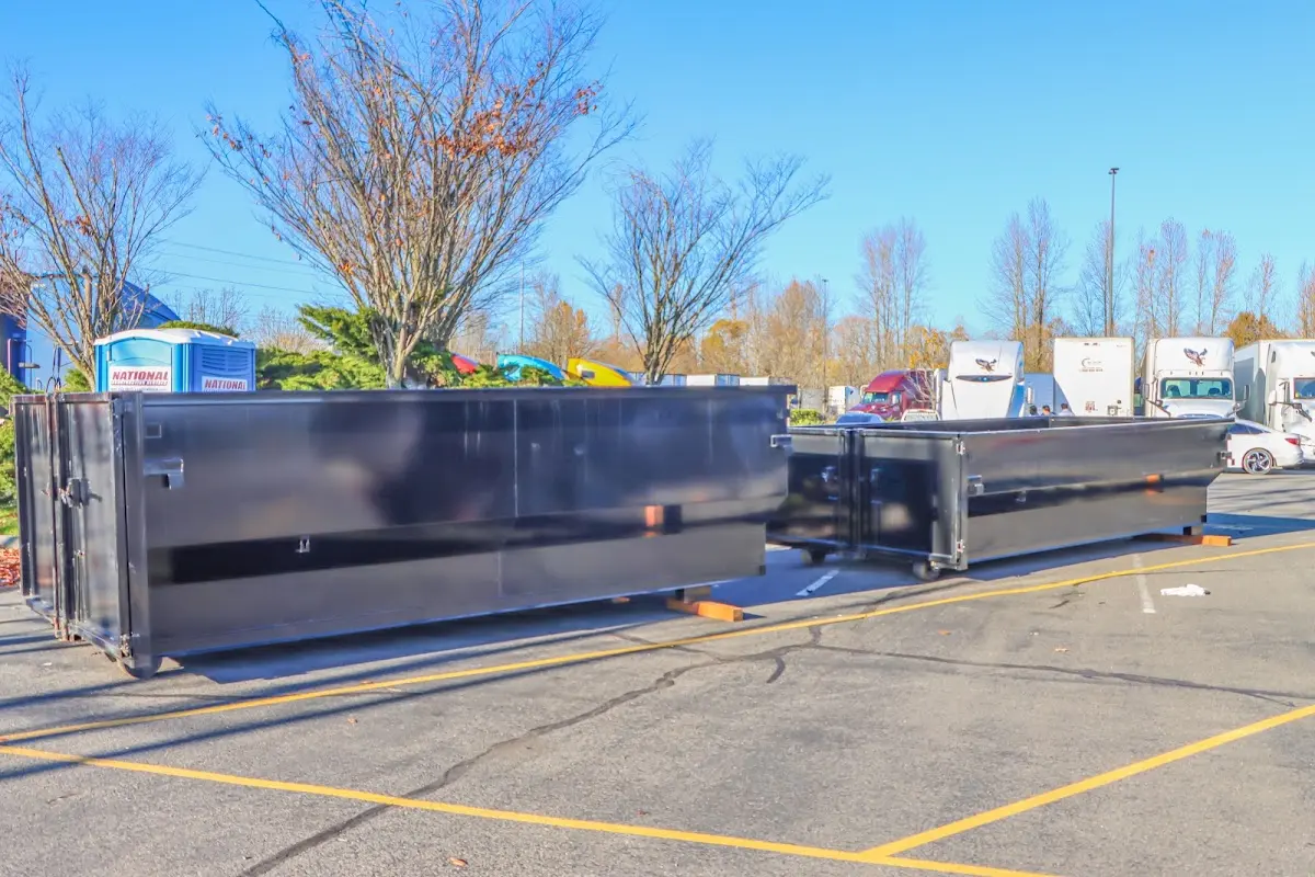 Professional dumpster rental service with roll-off container on residential driveway in Destin
